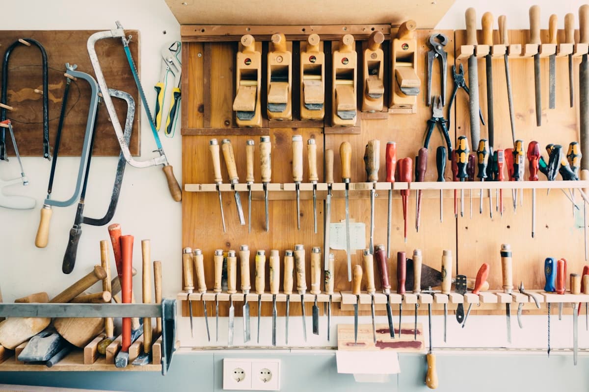 Hand tools arranged on a workshop wall rack